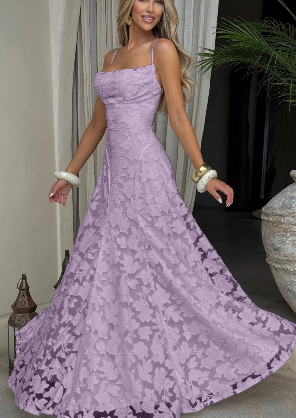 Woman wearing a purple lace dress in an indoor setting