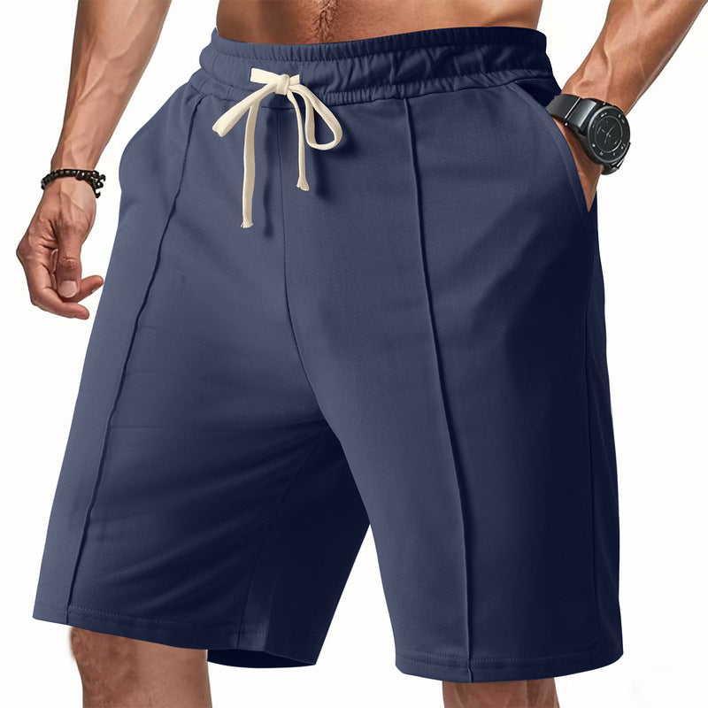Navy blue shorts with a drawstring on a white background