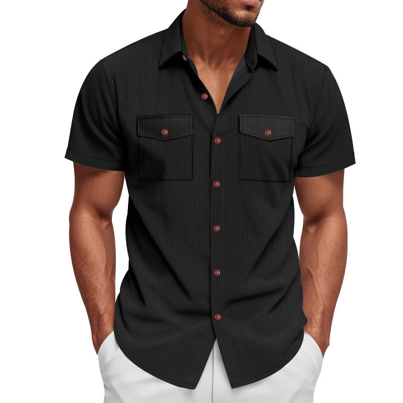 Man wearing a black short-sleeve shirt with red buttons on a white background