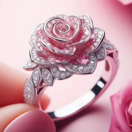 Pink rose-shaped ring with gemstones on a pink background