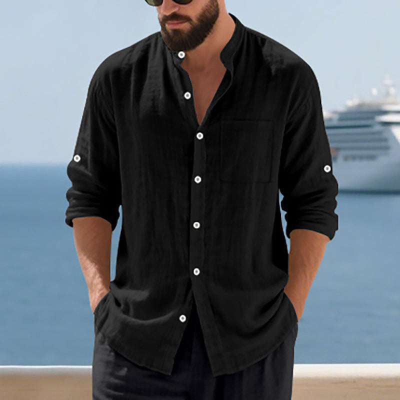 Man wearing a black button-up shirt with a cruise ship in the background