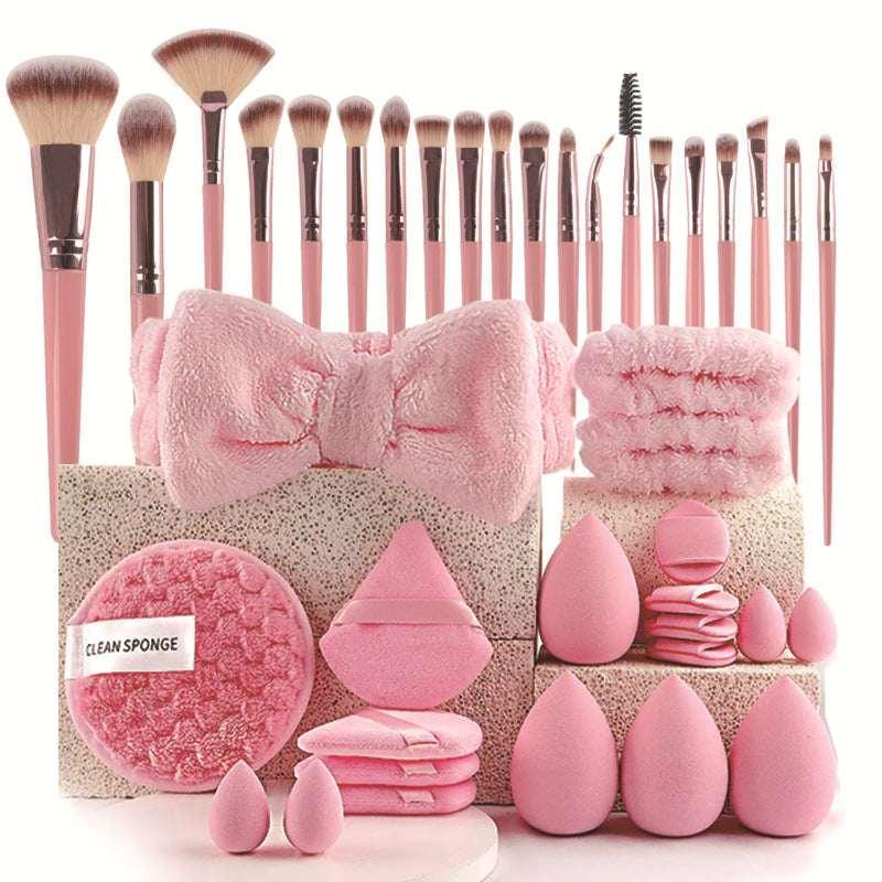 Pink makeup brush set with blending sponges, cleansing pads, and fluffy headband.