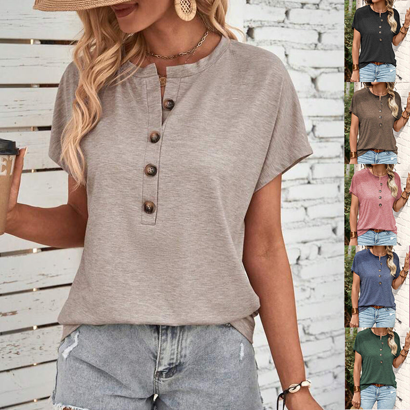 Woman wearing a button-up shirt and denim shorts against a wooden background