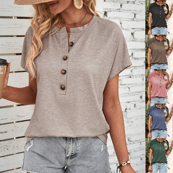 Woman wearing a button-up shirt and denim shorts against a wooden background