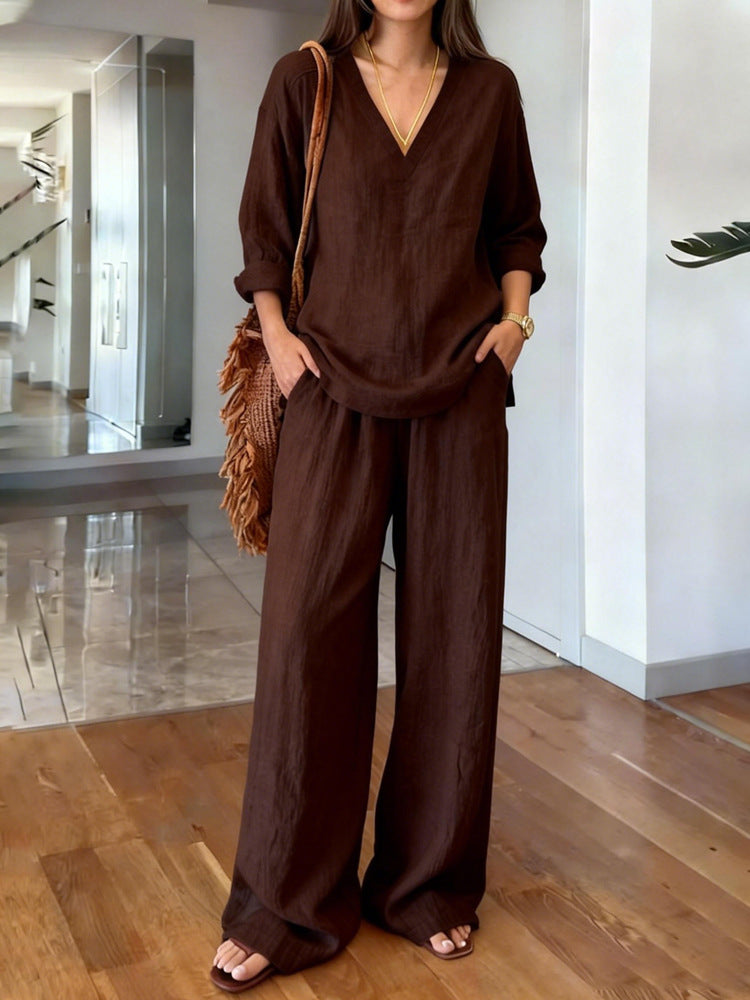 Person wearing a brown outfit standing in a modern indoor setting.