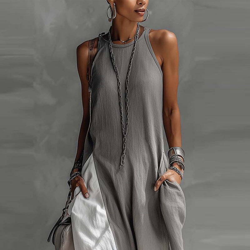 Woman wearing a gray sleeveless dress with a textured background