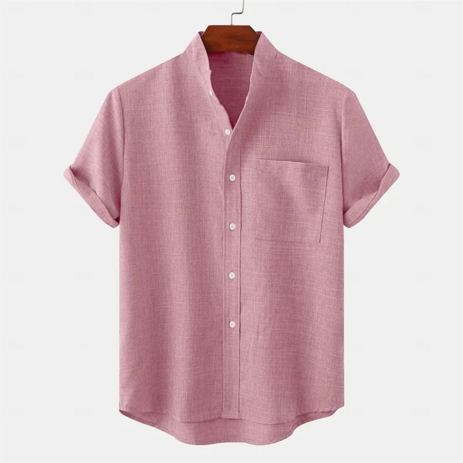 Pink short-sleeve shirt on a hanger with a white background