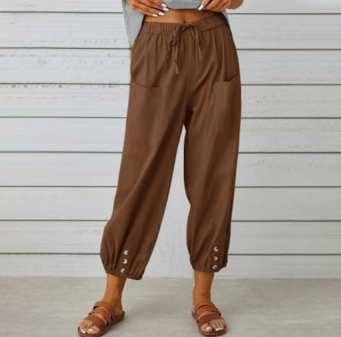 Brown pants worn by a person against a wooden background