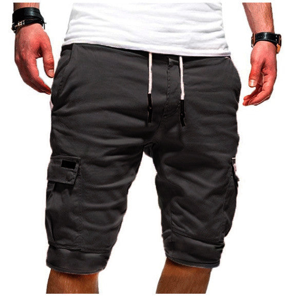 Black cargo shorts worn by a person on a white background