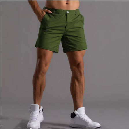 Person wearing green shorts on a gray background