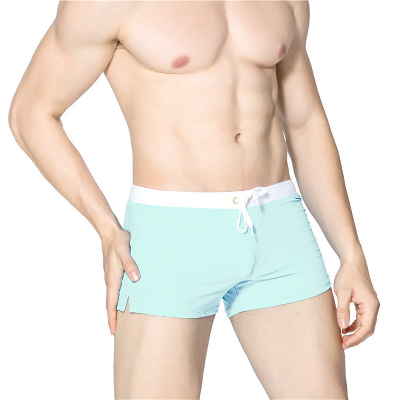 Light blue swim shorts worn by a person on a white background