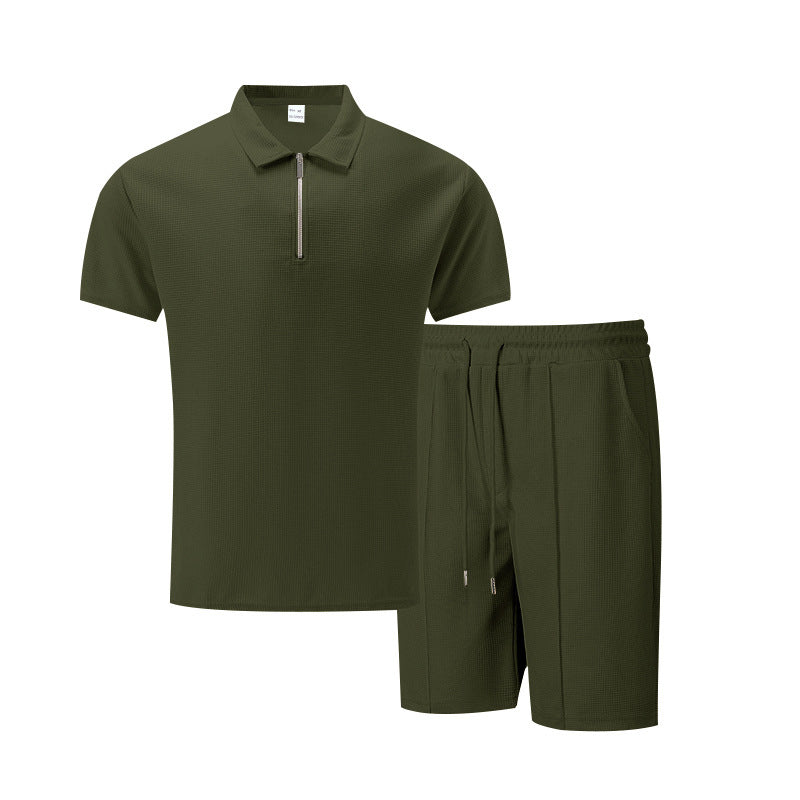 Black polo shirt and shorts set on a white background