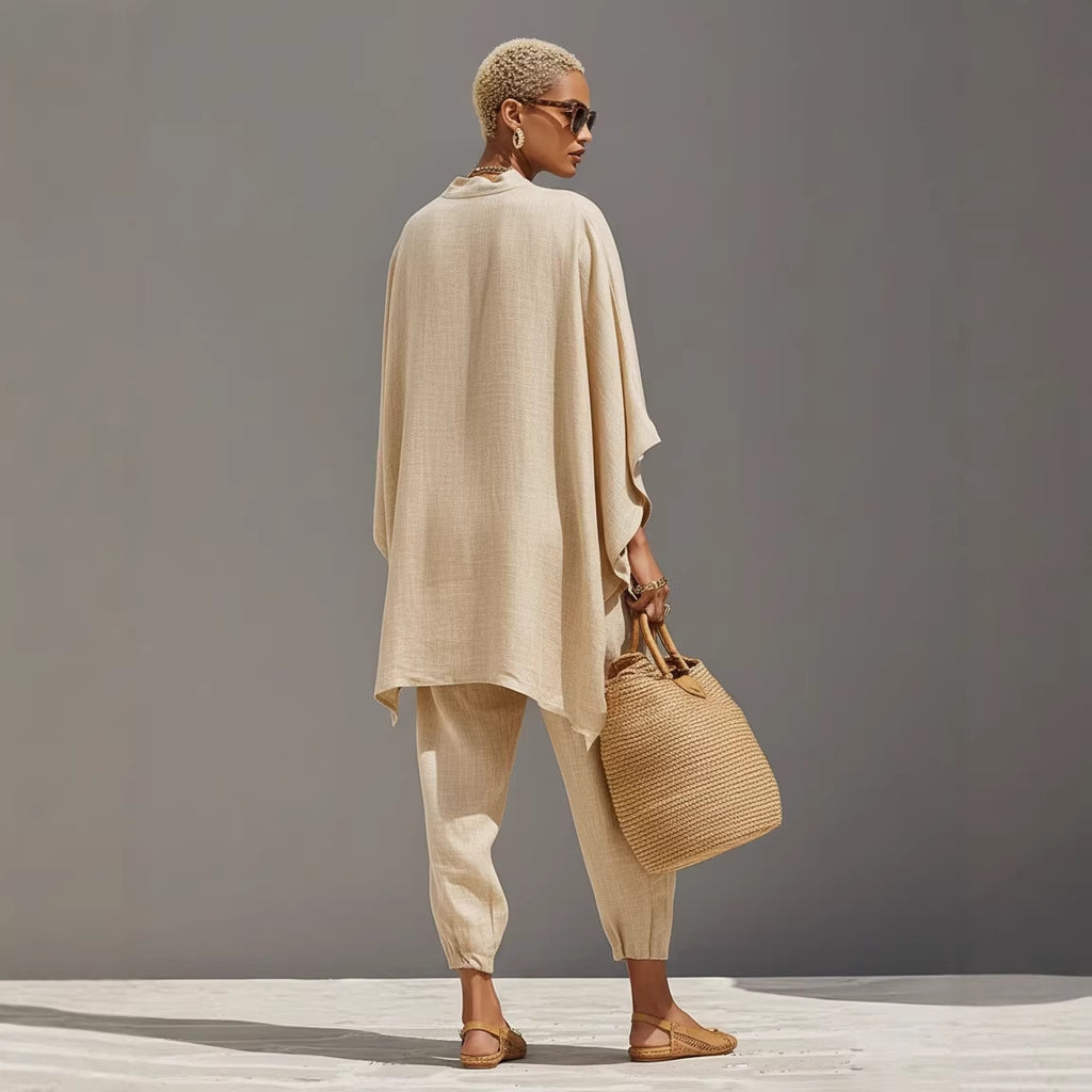 Woman in beige outfit holding a woven bag against a gray background