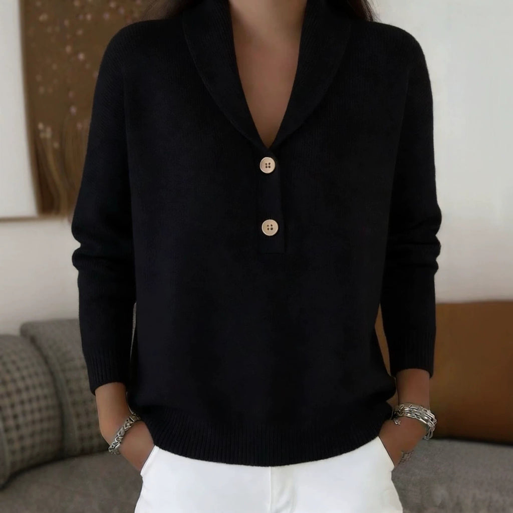 Person wearing a black sweater with buttons in a casual setting
