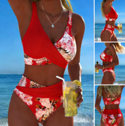 Woman in a red floral bikini holding a drink by the ocean