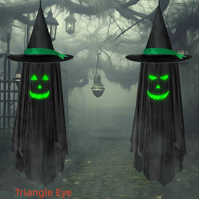 Two black witch hood Halloween decorations with glowing green jack-o'-lantern faces and bright green bands, shown hanging in a foggy, spooky forest scene. The text 'Triangle Eye' appears in red at the bottom left.