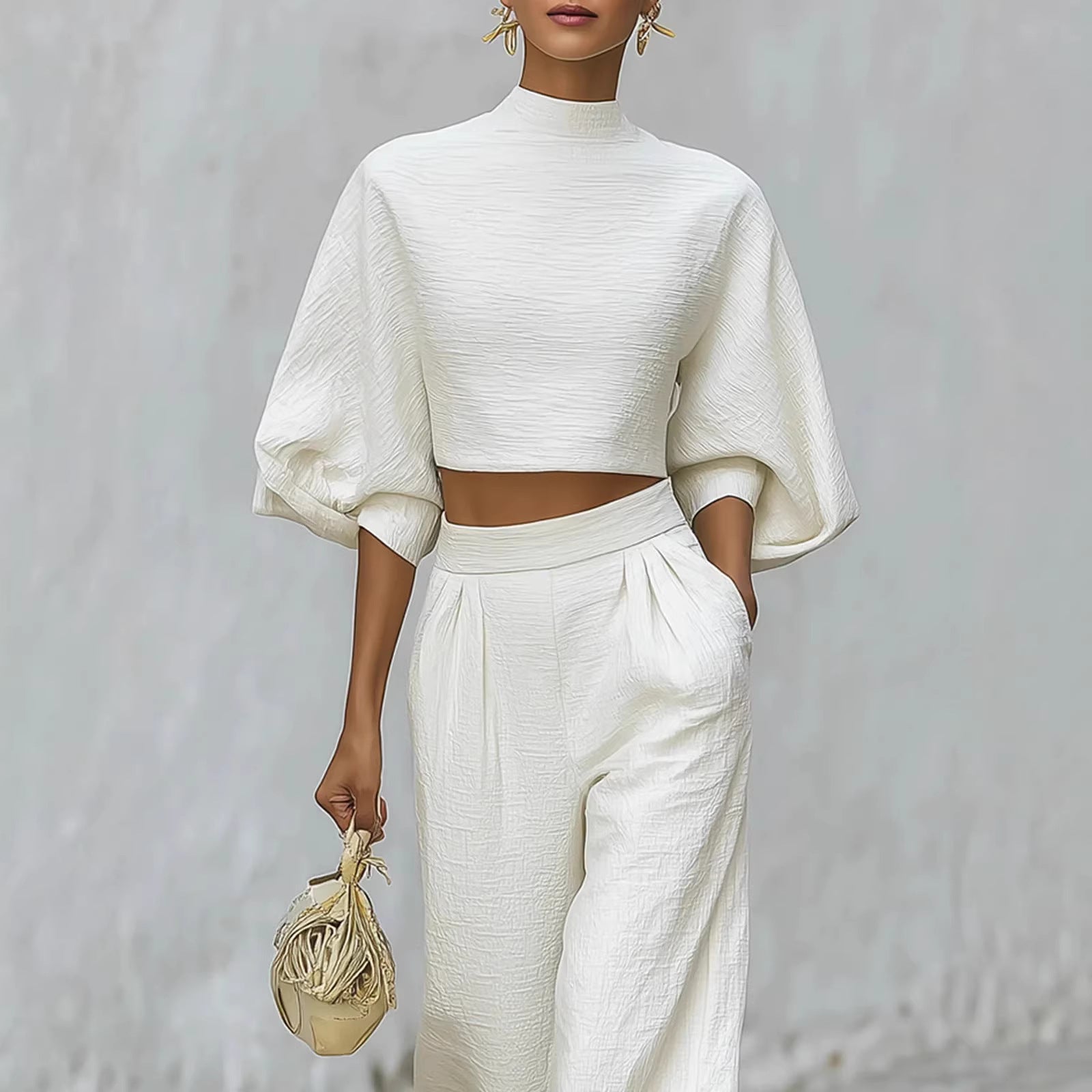 Person wearing a white outfit with a plain background