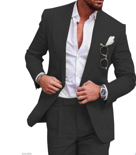 Man wearing a black suit with a white shirt and sunglasses on a white background