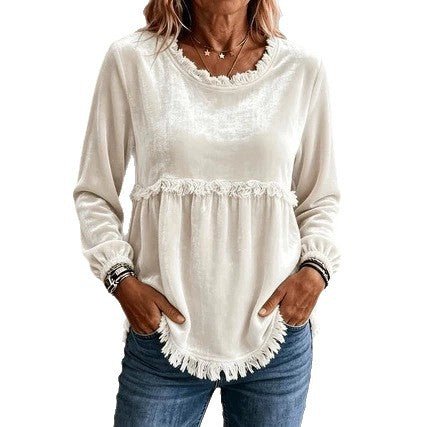 Woman wearing a white lace-trimmed top with long sleeves on a white background