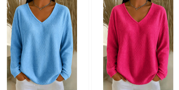 A side-by-side comparison of a women's ribbed knit V-neck sweater in two colors: light blue on the left and bright pink on the right, shown on a model wearing white pants.