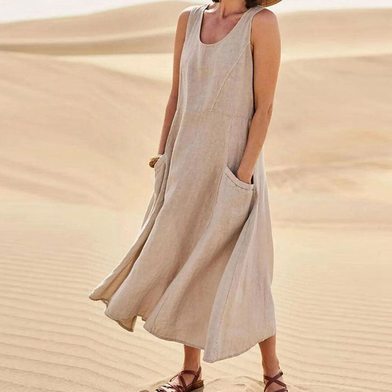 Person wearing a beige sleeveless dress in a desert setting