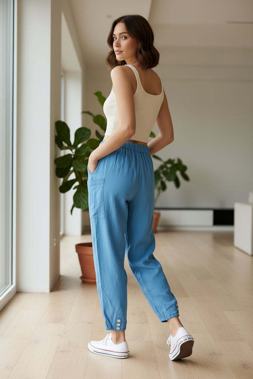 Blue pants worn by models on a light wooden floor.