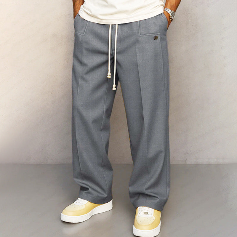 Person wearing gray pants with a white background