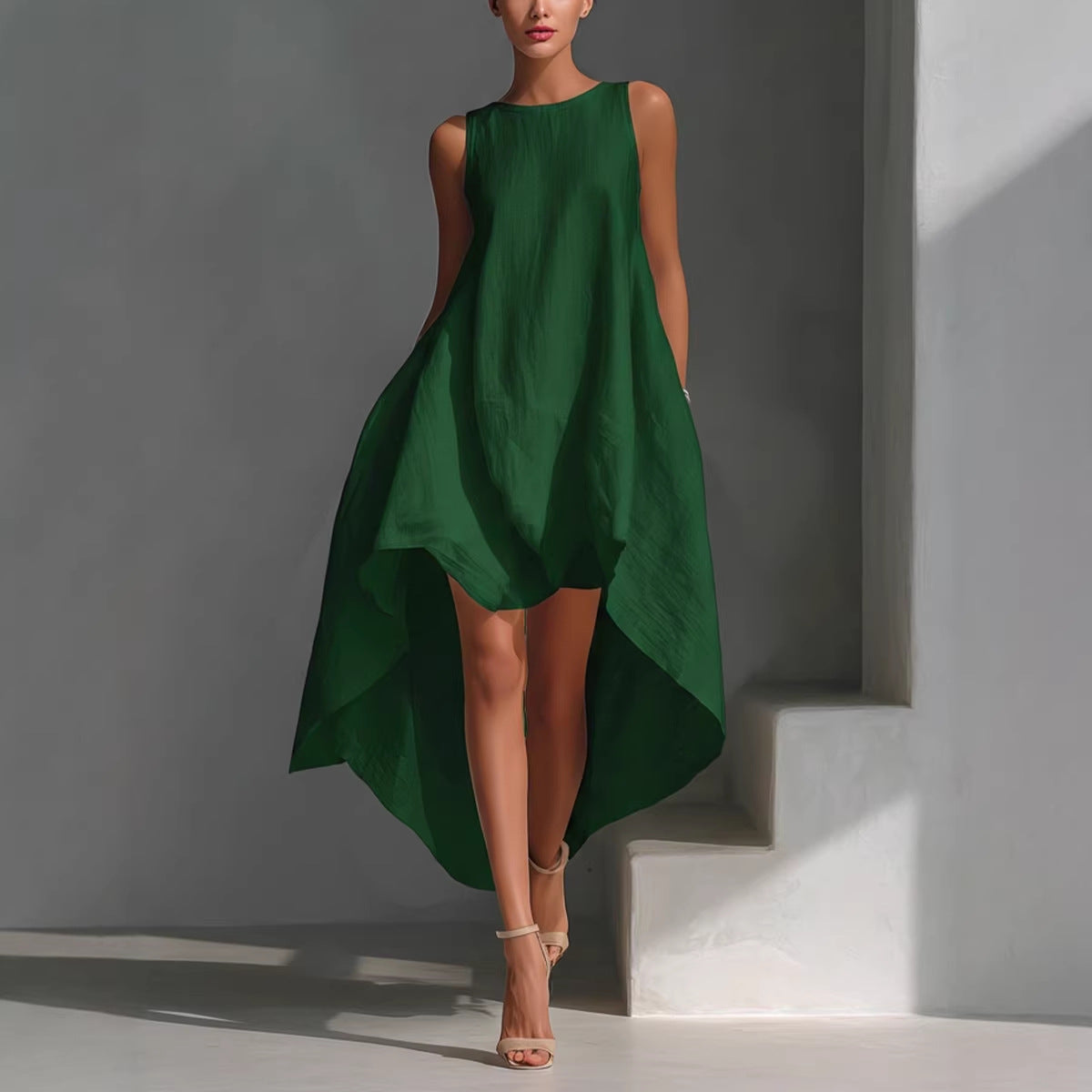 Green dress worn by a model against a gray background