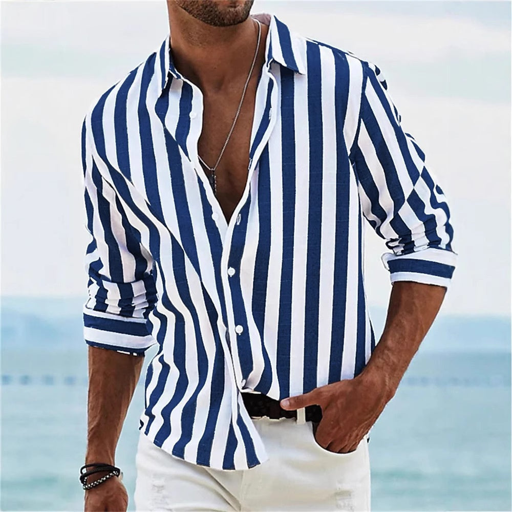 Man wearing a blue and white striped shirt with a blurred beach background