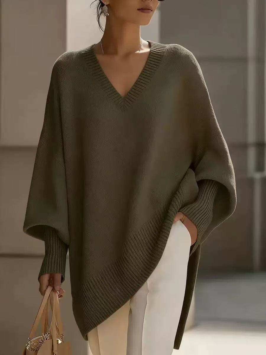 Person wearing a green poncho with a blurred background