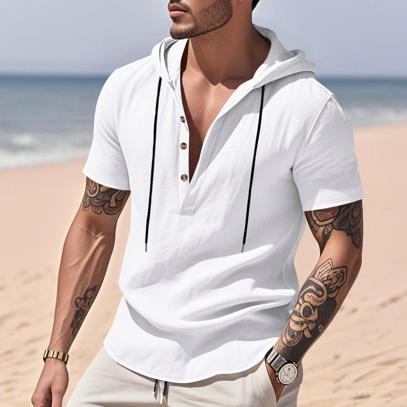 Man wearing a white hoodie on a beach