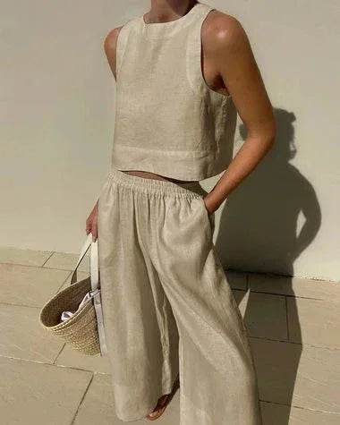 Woman wearing beige sleeveless linen top and wide-leg pants, holding woven tote bag, ZA-Zola fashion