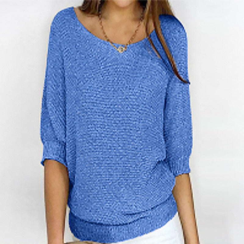 Blue textured top worn by a person on a white background