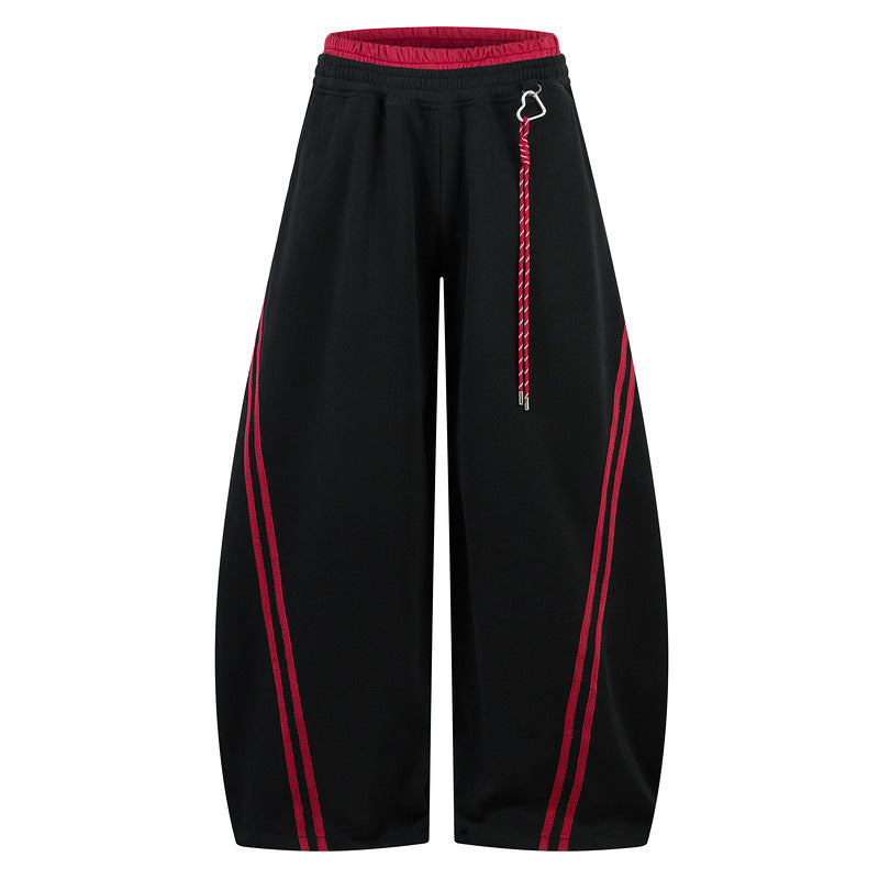 Black wide-leg pants with red stripes on a white background