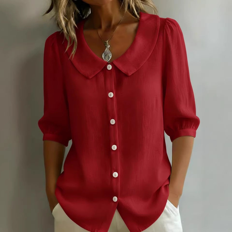 Red blouse with a collar and buttons on a plain background