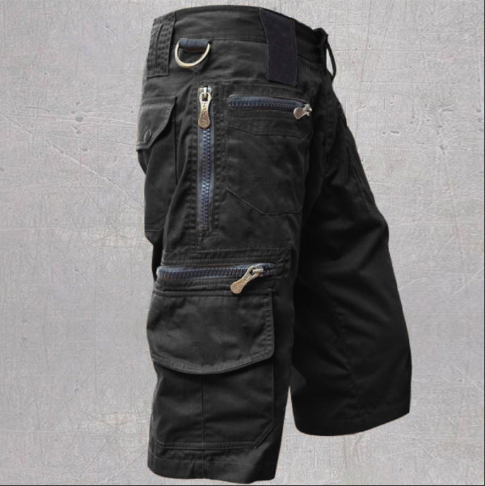 Black tactical pants with multiple pockets and zippers on a gray background