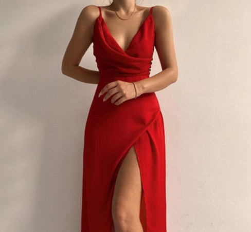 Red dress with a deep neckline and high slit on a plain background
