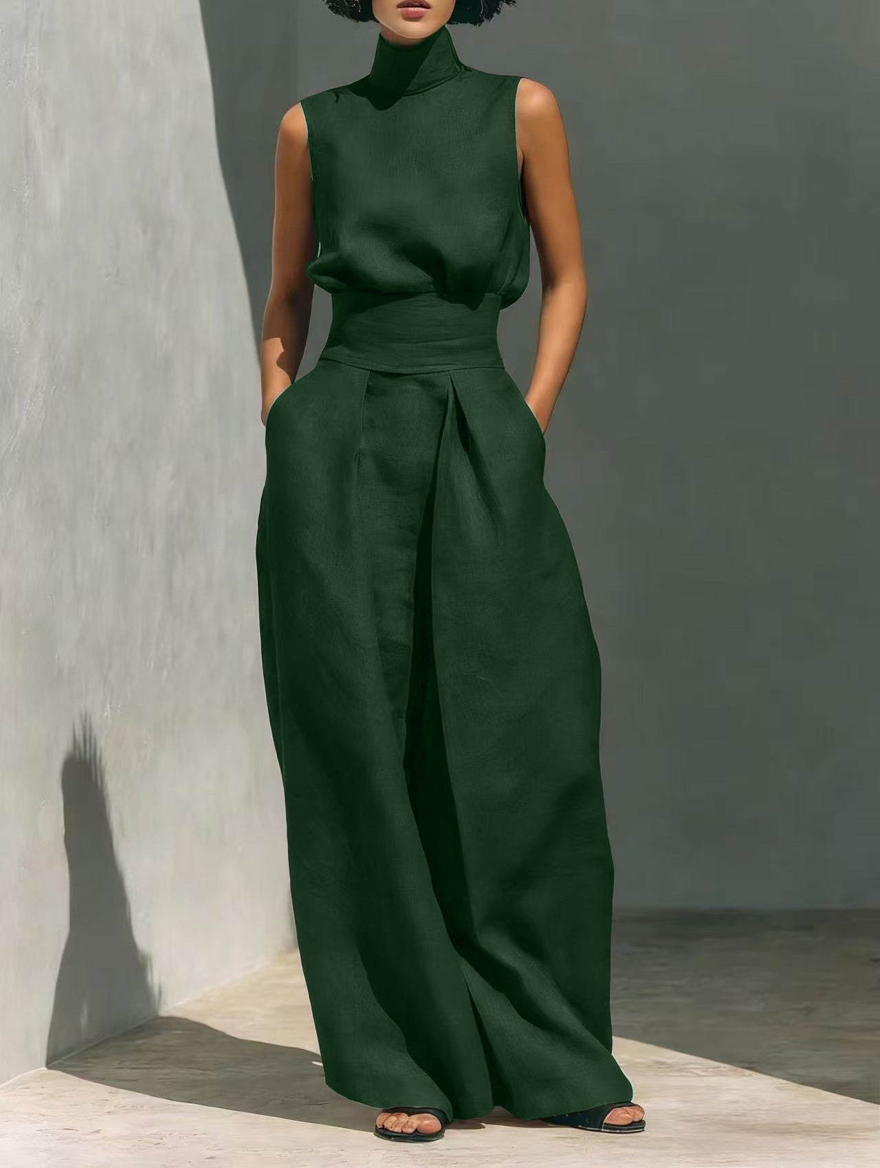 Person wearing a green outfit against a gray background