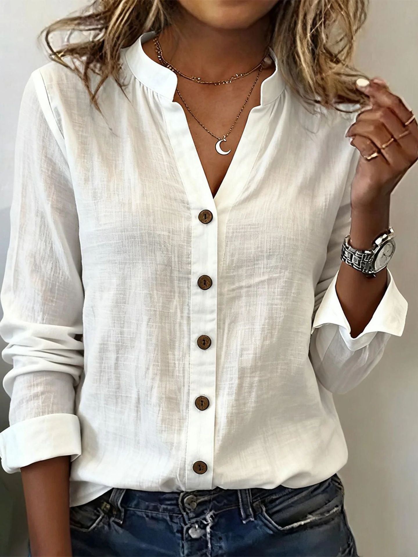 White button-up shirt worn by a person with a neutral background