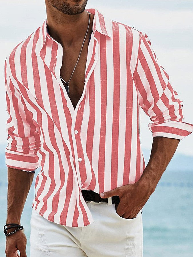 Man wearing a red and white striped shirt with a blurred beach background