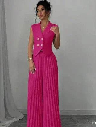 Woman wearing a vibrant pink pleated jumpsuit with sleeveless blazer top, ZA-Zola fashion