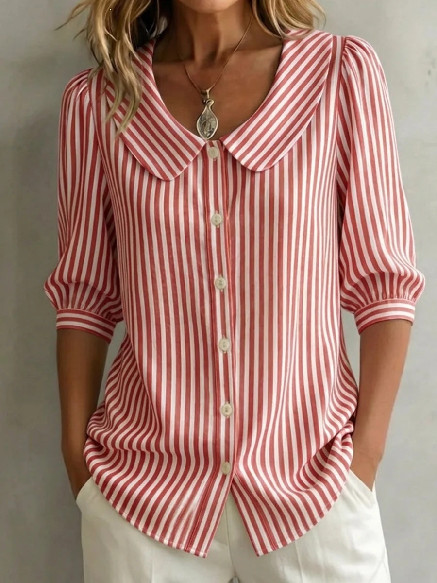 Red and white striped shirt worn by a person against a neutral background
