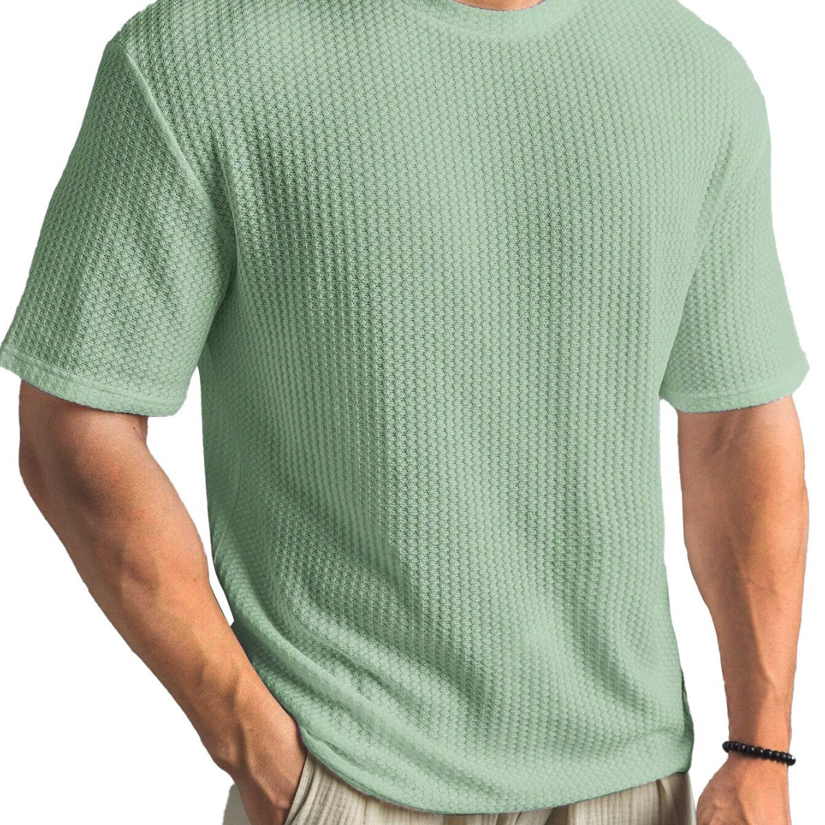Person wearing a textured green t-shirt on a white background