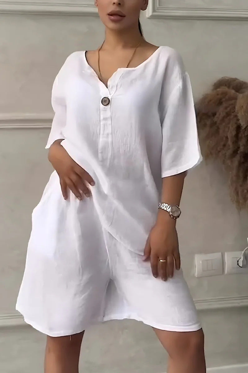 Person wearing a white outfit with a plain background
