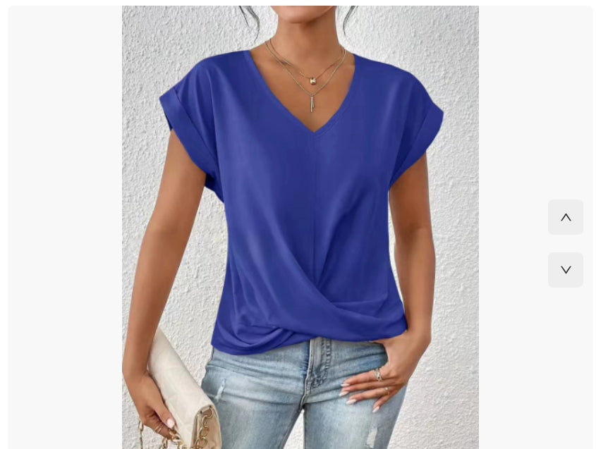 Woman wearing a blue top and light blue jeans against a white background