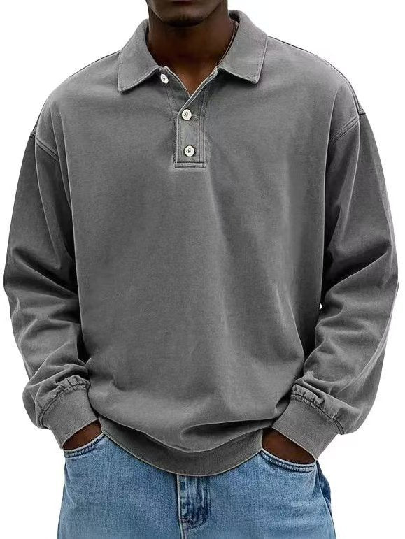 Person wearing a gray long-sleeve polo shirt with a collar.