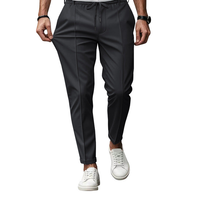 Black pants worn by a person on a white background