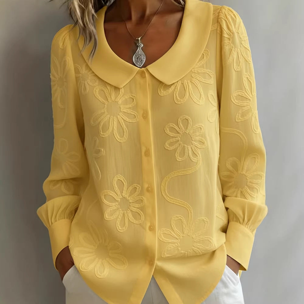 Yellow blouse with floral embroidery on a plain background