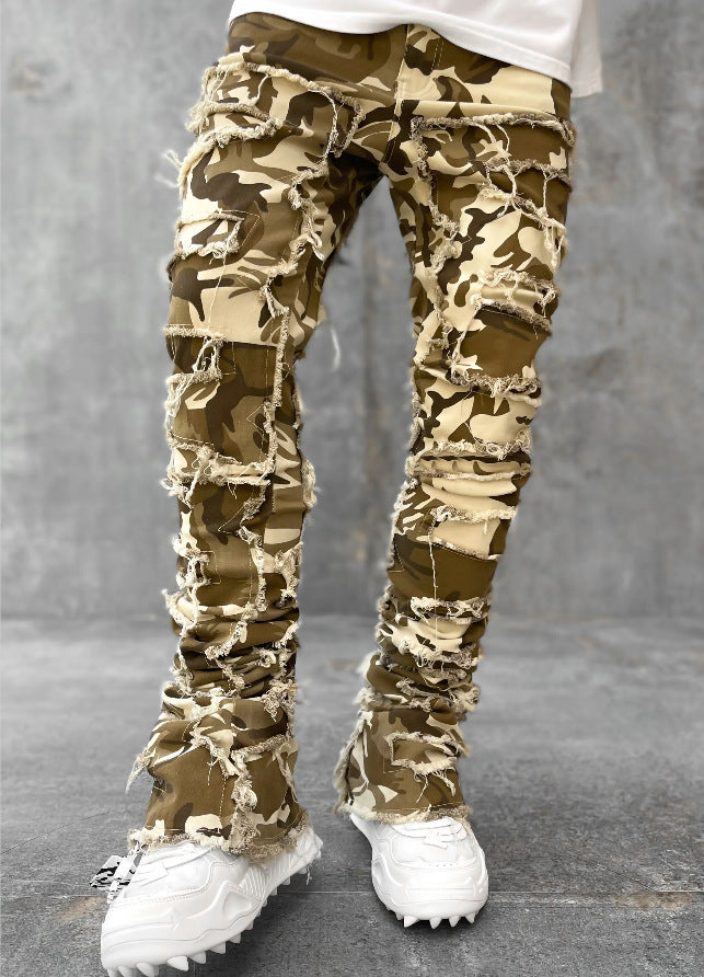 Camouflage pants worn by a person on a gray background