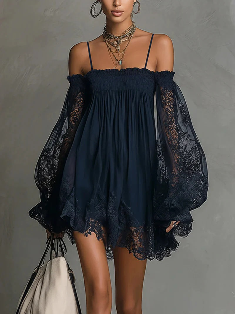Navy blue dress with sheer sleeves on a gray background